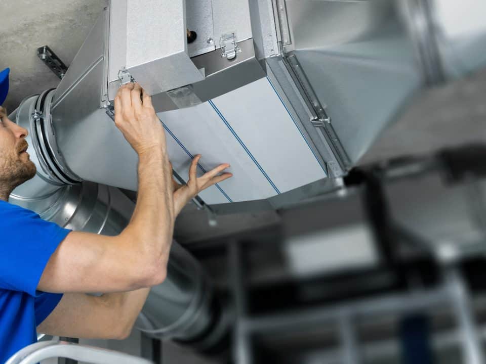 a man working on commercial air duct system