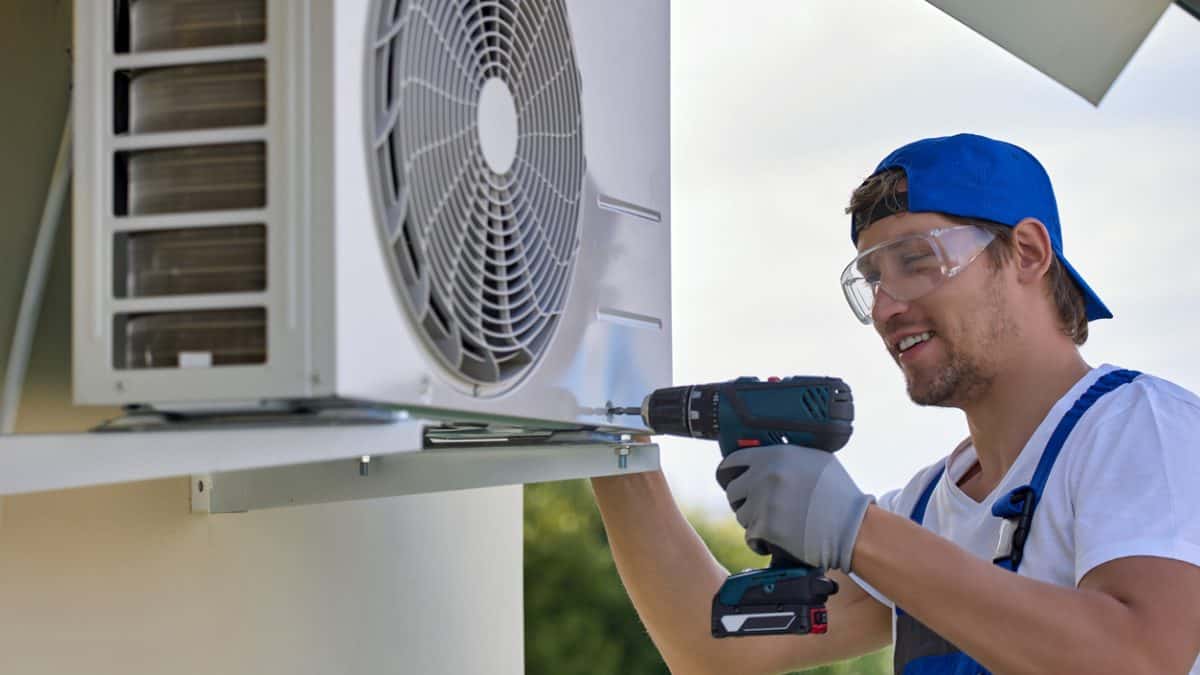 man with a tool doing HVAC maintenance