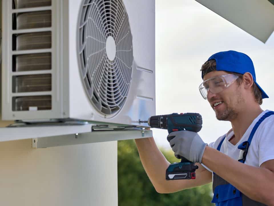 man with a tool doing HVAC maintenance